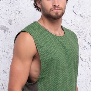 May include: A sleeveless shirt with a green and black geometric pattern. The shirt has a relaxed fit and a round neckline.