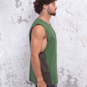 May include: A sleeveless shirt with a green and brown patterned design. The shirt has a scoop neck and a relaxed fit.