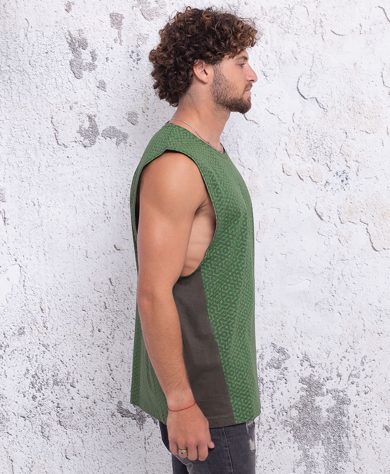 May include: A sleeveless shirt with a green and brown patterned design. The shirt has a scoop neck and a relaxed fit.