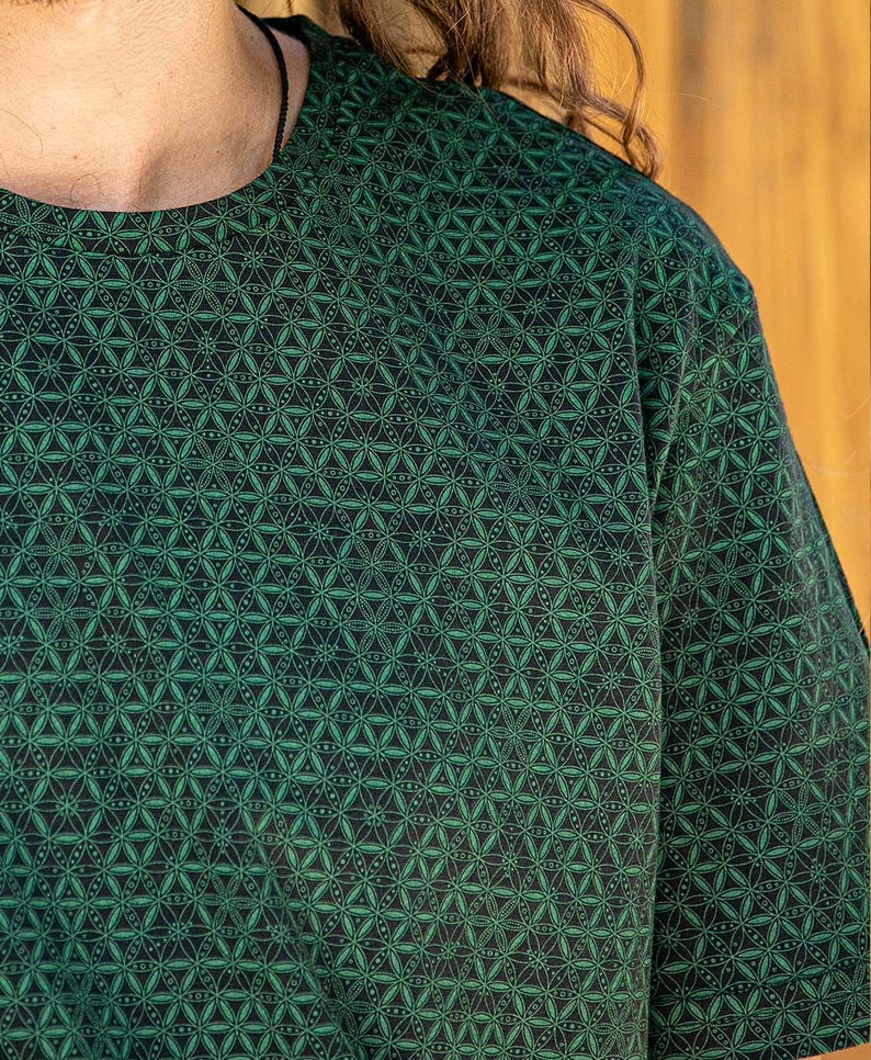 May include: A green short-sleeved shirt with a geometric pattern of small green circles and lines on a black background.