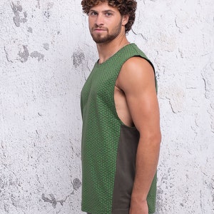 May include: A sleeveless shirt with a green and brown geometric pattern. The shirt has a scoop neck and a relaxed fit.