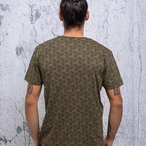 May include: A green short-sleeved t-shirt with a repeating pattern of small, stylized clover shapes.
