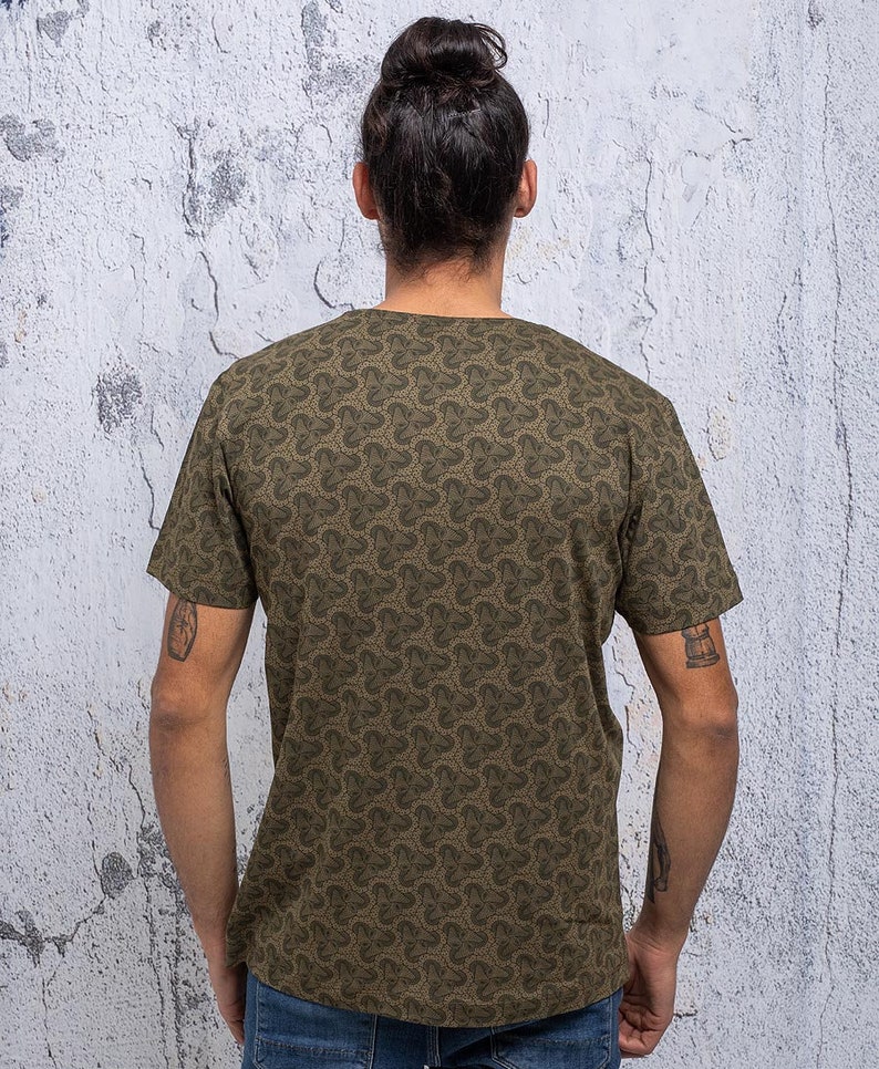 May include: A green short-sleeved t-shirt with a repeating pattern of small, stylized clover shapes.
