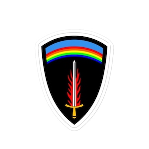 Peut inclure: Autocollant en forme de bouclier avec un fond noir, un arc-en-ciel et une épée stylisée. L'épée est rouge et blanche avec une poignée dorée. L'autocollant a une bordure blanche.