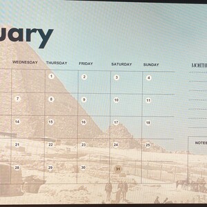 May include: A January calendar with a desert landscape background featuring pyramids and the Sphinx. The calendar grid is set against a light blue sky, with the month's name in bold black letters. Includes space for monthly goals and notes.