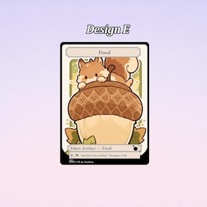 May include: A trading card featuring a cartoon squirrel atop a large acorn. The card has a black border with the text "Design E" at the top. The card is labeled "Food" and includes game text. The squirrel is brown and the acorn is tan.