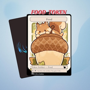 May include: A Food Token card with a cartoon squirrel perched on an acorn. The card has a white background with the word "Food" and "Token Artifact - Food". The top of the card reads "FOOD TOKEN".