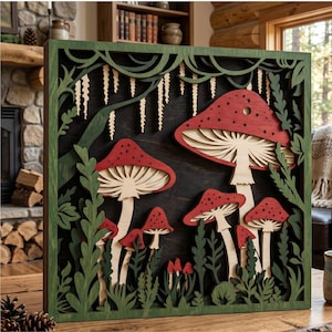 May include: Wooden wall art with a layered design of red and beige mushrooms and green foliage. The artwork is framed in a green border and set against a dark background, creating a three-dimensional effect. Designed for wall hanging, it adds a natural touch to any room.