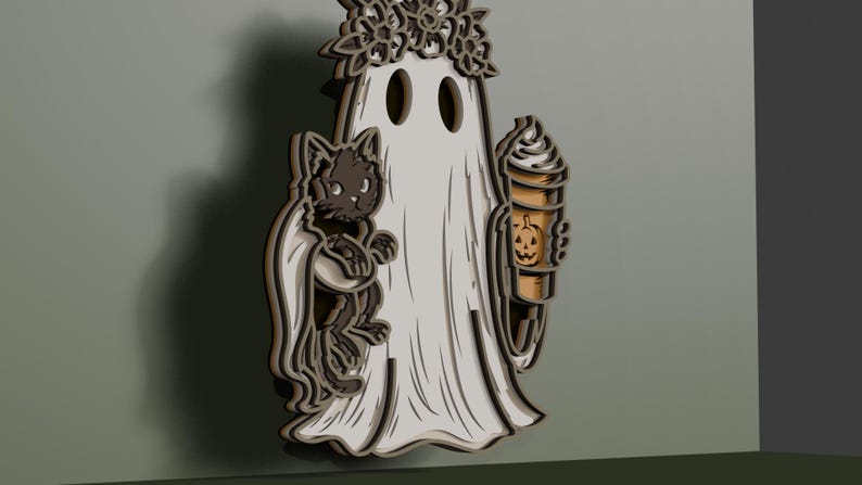 May include: A layered wooden wall decoration featuring a white ghost wearing a floral crown, holding a black cat on one side and a tan coffee cup with a jack-o'-lantern face design on the other. The piece has a dimensional, multi-layered appearance.