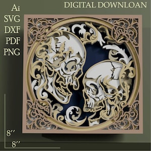 May include: A layered paper art piece featuring two skulls facing each other within a circular frame. The design incorporates intricate floral and scrollwork in shades of beige and gold, set against a dark blue background. The artwork is 8 inches by 8 inches.