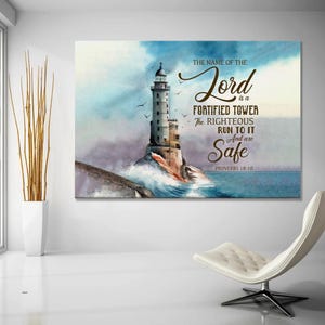 Peut inclure: Impression sur toile représentant une peinture à l'aquarelle d'un phare sur une côte rocheuse, avec des vagues déferlantes et des oiseaux en vol. Le texte indique "Le nom du Seigneur est une tour fortifiée". Proverbes 18:10.