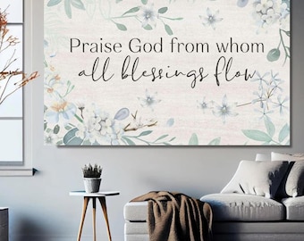 Puede incluir: Impresión en lienzo rectangular con el texto "Praise God from whom all blessings flow" en escritura negra. La impresión está decorada con detalles florales y de hojas en acuarela en tonos azules y verdes.