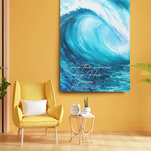 May include: A canvas print featuring a vibrant depiction of a large ocean wave in shades of blue and white. The artwork includes the text "Even the waves obey His voice Matthew 8:27" in elegant script. The print is displayed on a yellow wall.