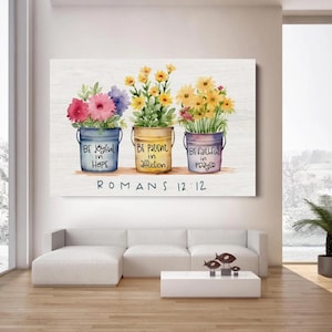 May include: A canvas print depicting three buckets of flowers with the text "BE joyful in HOPE", "BE patient in affliction", and "BE faithful in prayer". The text "ROMANS 12:12" is below. The flowers are pink, yellow, and purple.