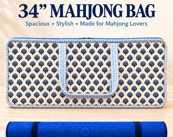 May include: A 34-inch rectangular Mahjong bag featuring a cream-colored fabric with a repeating blue floral pattern, blue striped piping, and two handles. Below the bag lies a solid blue rolled mat with two dark blue elastic bands.