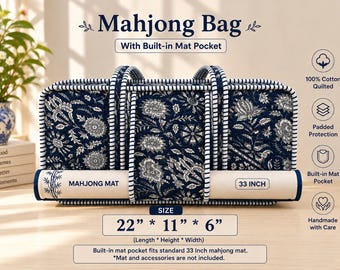 May include: A navy blue and white quilted mahjong bag with a floral pattern, featuring two handles and a built-in mat pocket. The bag measures 22 inches by 11 inches by 6 inches and includes a slot for a 33-inch mahjong mat. Text includes Mahjong Bag.