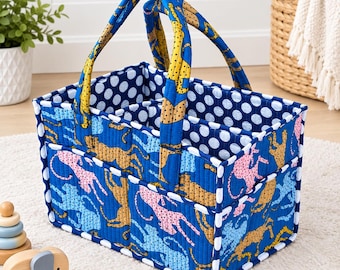 May include: A rectangular quilted fabric storage caddy featuring a vibrant blue background with a repeating pattern of pink, light blue, and yellow cheetahs. The interior and trim are decorated with a white polka dot pattern on a dark blue base.
