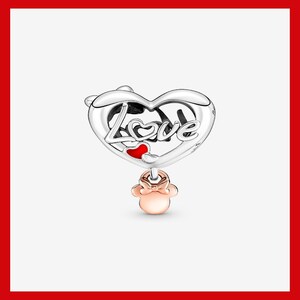 May include: A silver charm with a heart-shaped design. The word "Love" is inscribed on the heart, with a small red heart accent. A rose gold Minnie Mouse charm dangles below. The charm is likely for a bracelet or necklace.