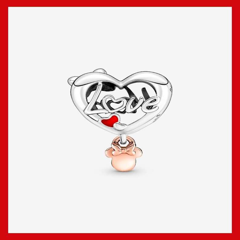 May include: A silver charm with a heart-shaped design. The word "Love" is inscribed on the heart, with a small red heart accent. A rose gold Minnie Mouse charm dangles below. The charm is likely for a bracelet or necklace.