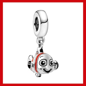 May include: A silver charm featuring a smiling cartoon fish with large eyes and red and white stripes. The charm has a loop at the top for attaching to a bracelet or necklace. The fish charm is a pendant.