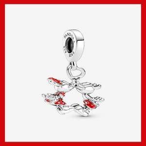 May include: A silver charm with a Mickey Mouse design. The charm features Mickey Mouse figures with red accents, forming a circular shape. The charm has a loop at the top for attachment and is marked with "PANDORA" and "S925".