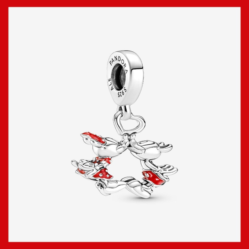 May include: A silver charm with a Mickey Mouse design. The charm features Mickey Mouse figures with red accents, forming a circular shape. The charm has a loop at the top for attachment and is marked with "PANDORA" and "S925".