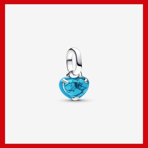 May include: A heart-shaped charm pendant with a vibrant turquoise stone. The pendant is suspended from a silver-colored bail. The turquoise stone has a unique, marbled appearance, and the charm is set in a silver-toned metal.