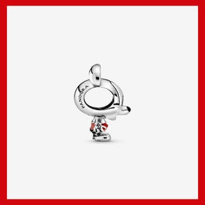 May include: A silver charm with a Mickey Mouse design. The charm features a round loop with the word "Pandora" engraved on it. Mickey's head and body are visible, with red accents on his shorts and shoes.