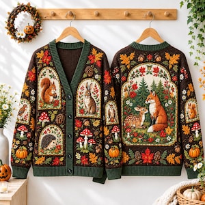 May include: A dark brown knit cardigan and a matching pullover sweater featuring intricate autumn-themed patterns. The designs include woodland animals like a fox, deer, squirrel, rabbit, and hedgehog, surrounded by colorful fall leaves, mushrooms, and pumpkins.