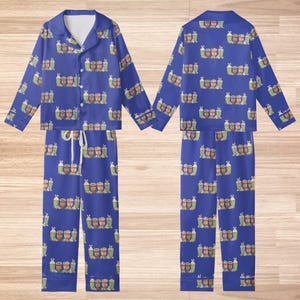 May include: A white ceramic mug with a black handle and the text "But First, Coffee" in a black, handwritten-style font. The mug is on a white surface.