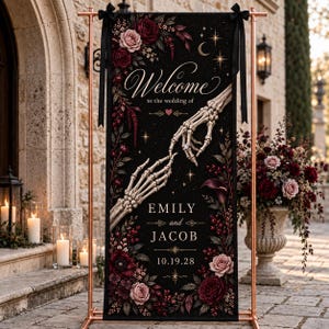 May include: A vertical black wedding welcome sign featuring two skeletal hands reaching toward each other, adorned with deep red and blush roses, stars, and a crescent moon. The text reads Welcome to the wedding of Emily and Jacob 10.19.28.