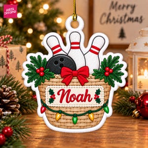 May include: A hanging Christmas ornament shaped like a woven basket containing a black bowling ball and three white bowling pins with red stripes. The basket features a red bow, green holly leaves with red berries, and a string of colorful lights.