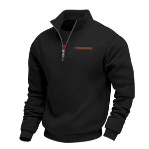 May include: Black quarter-zip sweatshirt with a high collar and a brown rectangular patch on the chest. The zipper is silver with a red and white accent. The sweatshirt has long sleeves and a ribbed hem.