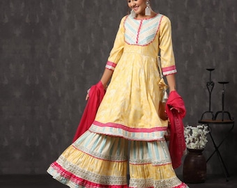 May include: A yellow knee-length tunic with three-quarter sleeves, featuring a light blue and white striped bodice panel, paired with matching wide-leg palazzo pants. The outfit is accented with bright pink trim and silver metallic embroidery.