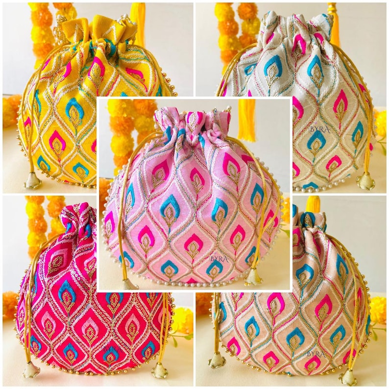 May include: A collage of five drawstring pouches in various colors: yellow, pink, and off-white. Each pouch features an embroidered peacock feather design in contrasting colors, with gold accents and beaded trim. The pouches have gold drawstrings and tassels.