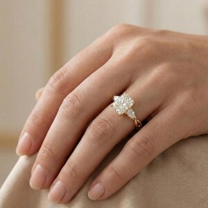 Three-stone pear diamond radiant ring by ExcellentJewels, ideal engagement or anniversary piece. Handcrafted fine jewelry with elegance, durability, and customizable features. Timeless design suitable for special occasions or everyday wear. A meaningful, sparkling gift for couples or anyone seeking high-quality diamond jewelry. Nature themed gold diamond ring with radiant center stone and pear accents.