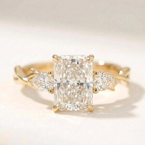 Radiant three-stone ring by ExcellentJewels featuring a pear-shaped diamond trio. Elegant design perfect for engagement, anniversary, or special occasions. Handcrafted for brilliance and durability, offering timeless style. Customizable to suit personal preferences. Ideal gift for loved ones or a statement piece in any fine jewelry collection.
