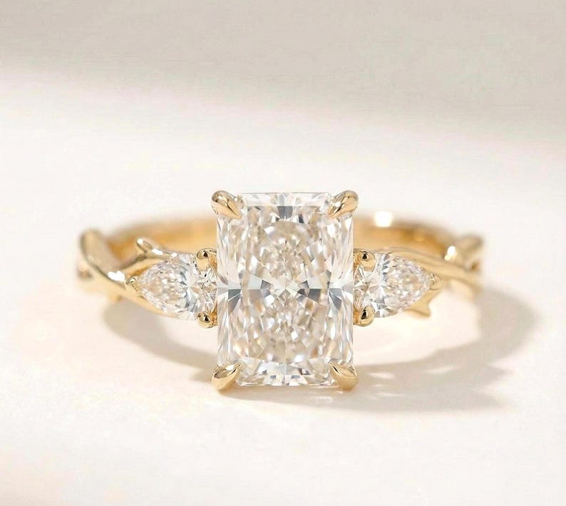 Radiant three-stone ring by ExcellentJewels featuring a pear-shaped diamond trio. Elegant design perfect for engagement, anniversary, or special occasions. Handcrafted for brilliance and durability, offering timeless style. Customizable to suit personal preferences. Ideal gift for loved ones or a statement piece in any fine jewelry collection.