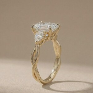 Custom gold radiant three-stone pear diamond ring by ExcellentJewels, designed for elegant engagements. The pear-shaped center diamond shines brilliantly with two sparkling side stones, offering a luxurious and timeless design. Ideal as a fine jewelry gift for anniversaries, proposals, or personal collection, combining classic charm with modern refinement.