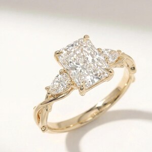 ExcellentJewels three-stone ring with pear-shaped diamonds in a radiant setting. Stylish engagement or anniversary ring with custom options. Handcrafted for elegance, sparkle, and long-lasting quality. Perfect for daily wear or special occasions. Makes a thoughtful, sophisticated gift for weddings, proposals, or personal fine jewelry collection.