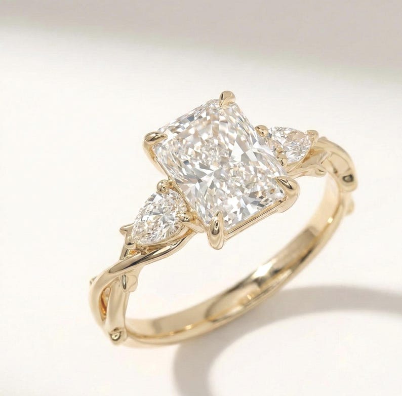 ExcellentJewels three-stone ring with pear-shaped diamonds in a radiant setting. Stylish engagement or anniversary ring with custom options. Handcrafted for elegance, sparkle, and long-lasting quality. Perfect for daily wear or special occasions. Makes a thoughtful, sophisticated gift for weddings, proposals, or personal fine jewelry collection.