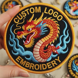 May include: Embroidered patch with a detailed dragon design. The patch features a red, yellow, and blue dragon on a black background, with the words "CUSTOM LOGO EMBROIDERY" in yellow. The patch has a gold border.