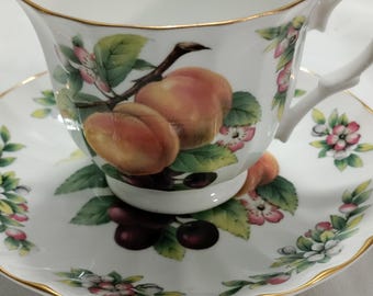 Vintage Crown Trent cup and saucer set is made of fine bone china in Staffordshire, England, and features a detailed "Peaches and Cherries"