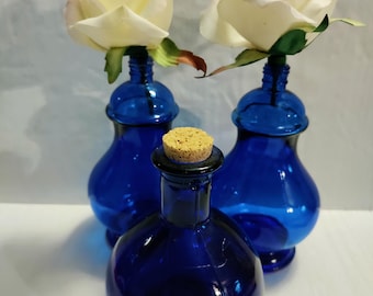 3 vintage decorative cobalt blue bottles Avon they would look great with one rose in it for decorations to go with your blue willow