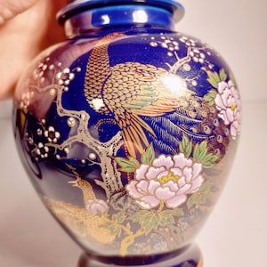 Vintage Asian porcelain Peacock ginger jar, also known as a temple jar, featuring cobalt blue and gold accents.