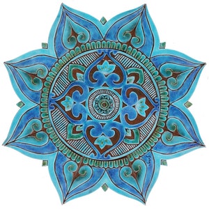 Op de afbeelding: Een blauwe en groene keramische mandala met ingewikkelde patronen en een bruin centrum. De mandala heeft de vorm van een bloem met acht bloemblaadjes.