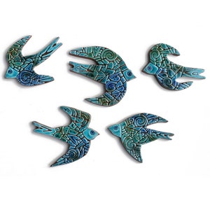 May include: Five ceramic swallow birds in shades of blue and green with intricate patterns. The birds are in flight and are arranged in a staggered pattern.