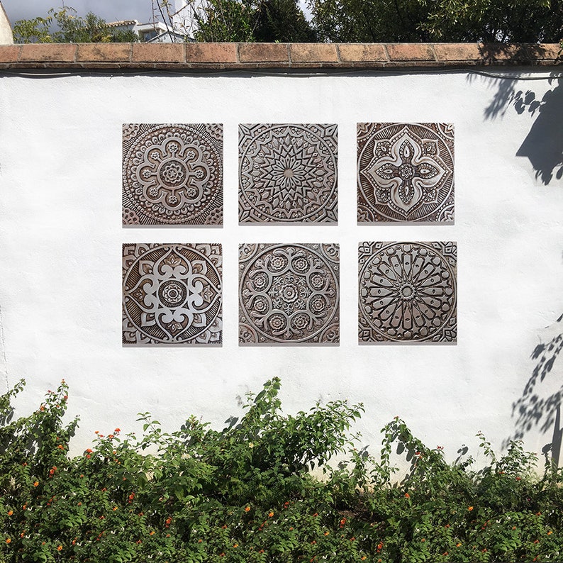 May include: Six square wall tiles with intricate, carved, mandala-like designs in shades of brown and white.