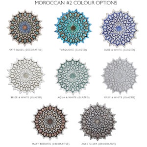 May include: Eight decorative ceramic wall plates with a Moroccan design. The plates feature a variety of colors and finishes, including matt blues, turquoise, blue and white, beige and white, aqua and white, grey and white, matt browns, and aged silver.