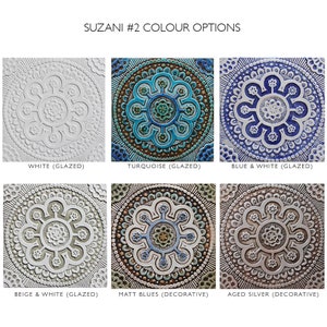 May include: Six ceramic tiles with intricate floral patterns in various color combinations. The tiles are labeled with their color options: White (Glazed), Turquoise (Glazed), Blue & White (Glazed), Beige & White (Glazed), Matt Blues (Decorative), and Aged Silver (Decorative).